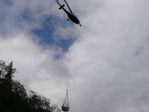 Bringing the yurt to the site by helicopter.